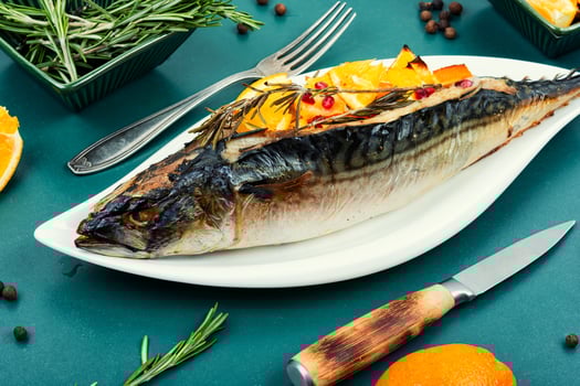 Baked whole fish grilled on a plate. photo