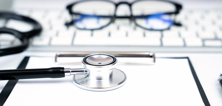 Doctor's stethoscope, glasses and clipboard. Doctor's workplace. Banner. Close-up. Selective focus. photo
