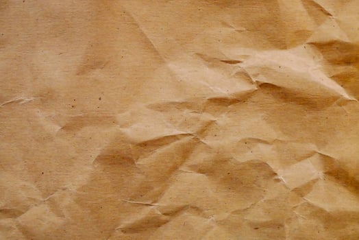 a brown paper texture with crumpled edges photo