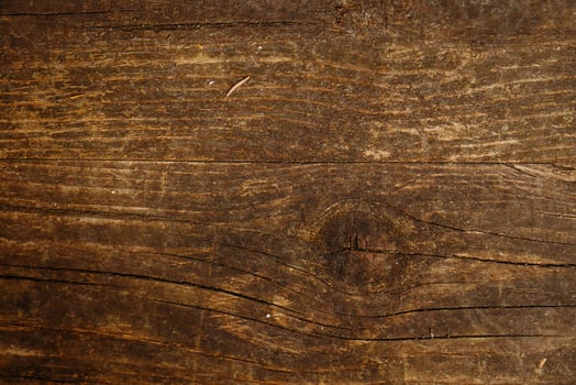 a close up of a wooden surface with a knot photo