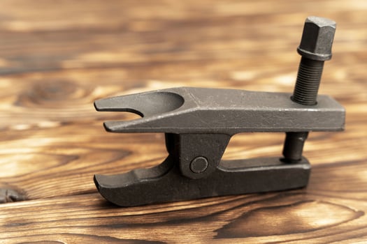 The metal puller of the ball bearings of the car on a wooden table. a tool for a garage or service photo