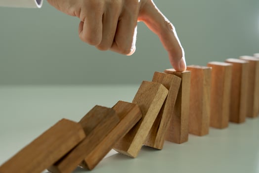 insurance with hands protect domino. Businessman hands stop dominoes falling in business crisis. business risk control and planning and strategies to run prevent insurance businesses. photo