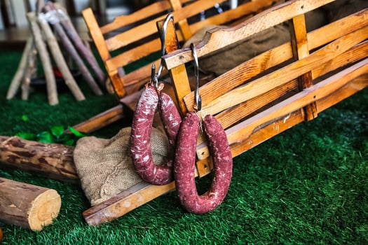 Sausages Hanging From Wooden Bench photo