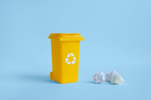 Yellow container and crumpled paper photo