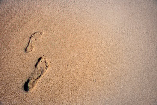 Human footprints in the sand photo