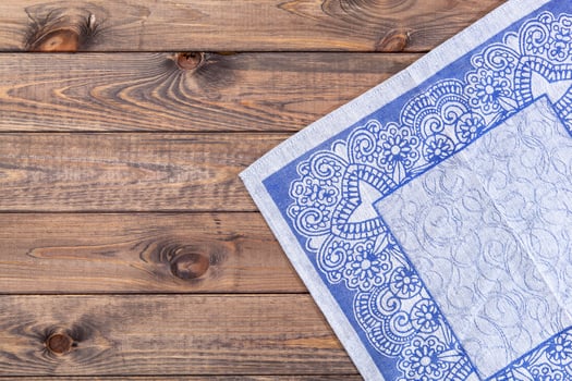 Blue cloth on wooden table, top view photo