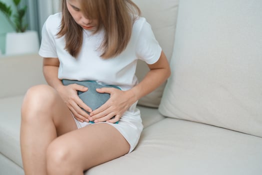 Menstruation period cycle of monthly and Stomachache concepts. woman having abdomen pain and menstrual ache with hot water bottle, illness female suffer from premenstrual ache and body Health problem photo