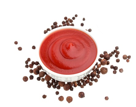 Ketchup and black pepper isolated on white photo