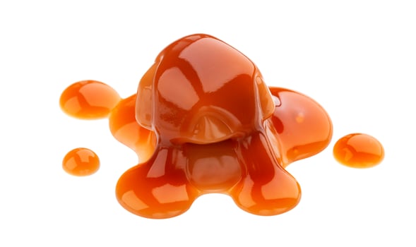 Caramel candies and caramel sauce isolated on white background photo