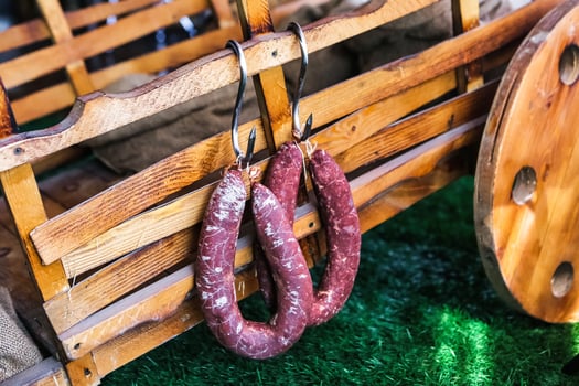 Two Sausages Hanging From a Wooden Wagon photo