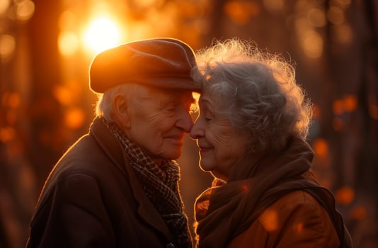An elderly couple together in a romantic setting at sunset photo
