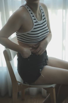 Women body fat belly. Obese woman hand holding excessive belly fat. diet lifestyle concept to reduce belly and shape up healthy stomach muscle. photo