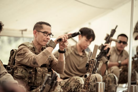 Soldiers in camouflage uniforms planning on operation in the camp, soldiers training in a military operation photo