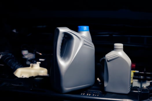 lubricant bottle On the background of engine lubricant, oil change shop, engine service industry. photo