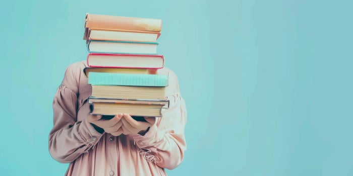 hands holding stacks of books photo