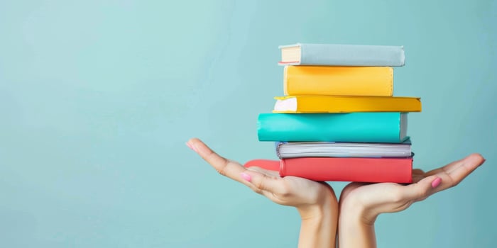 hands holding stacks of books photo