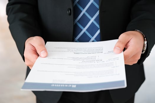 Close-Up of Businessman Holding a Resume. photo