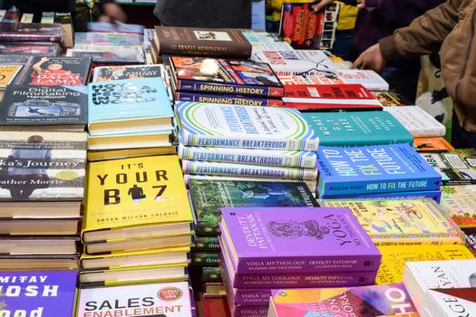 New Delhi, India, February 17 2024 - Variety of Books on shelf inside a book-stall at Delhi International Book Fair, Selection of books on display in Annual Book Fair at Bharat Mandapam complex photo