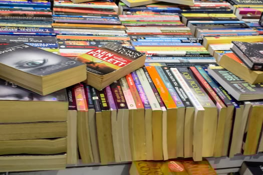 New Delhi, India, February 17 2024 - Variety of Books on shelf inside a book-stall at Delhi International Book Fair, Selection of books on display in Annual Book Fair at Bharat Mandapam complex photo
