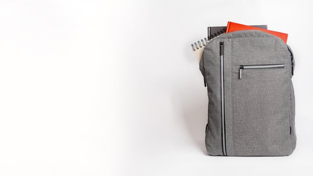 Books, notebooks picking out from backpack. Banner background photo