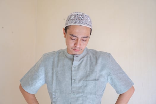 Moslem Asian man sad gesture when Ramadan celebration. The photo is suitable to use for Ramadhan poster and Muslim content media.