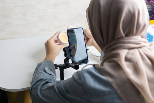 Woman with hijab preparing the recording mobile phone to make a and produce content photo