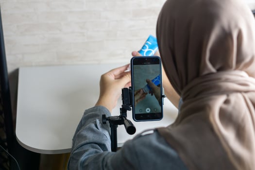 Woman with hijab preparing the recording mobile phone to make a and produce content photo