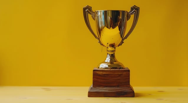 Silver Trophy on Wooden Stand photo