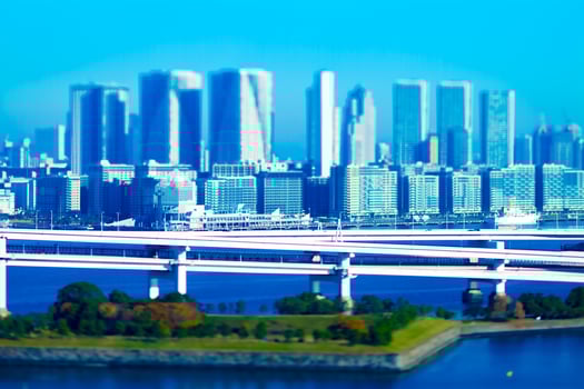 Moving cars on the miniature highway at the urban city in Tokyo tiltshift photo