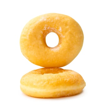 Front view of two sugar glazed cinnamon donuts in stack isolated on white background with clipping path photo