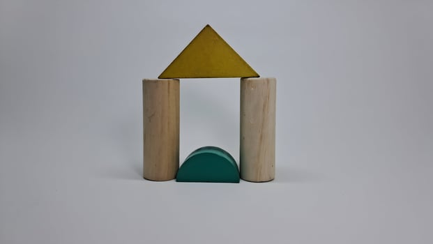 a wooden toy with a triangle and a green triangle photo