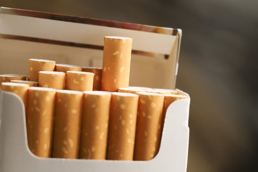 peel it off Cigarette pack prepare smoking on white wooden background. Packing line up. photo filters Natural light