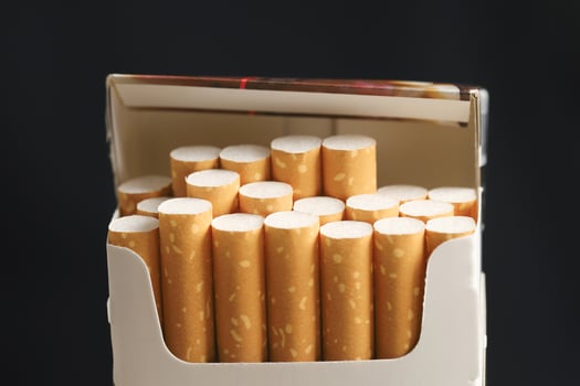 peel it off Cigarette pack prepare smoking on white wooden background. Packing line up. photo filters Natural light
