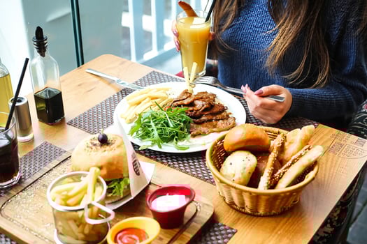 Woman Sitting at Table With Plate of Food photo
