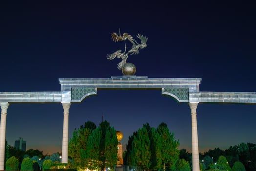 Tashkent, Uzbekistan - August 12, 2023 Memorial of Independence with illumination in the Independence Square at summertime in nighttime. photo