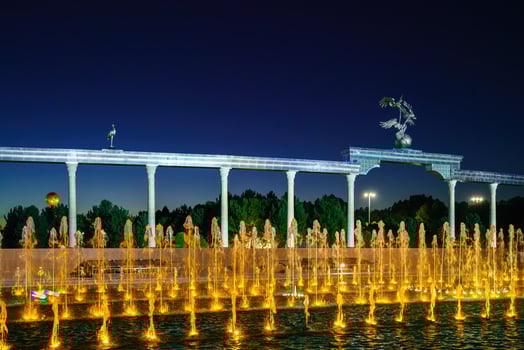 Memorial and rows of fountains with illumination in the Independence Square at summertime in nighttime, Tashkent, Uzbekistan. photo