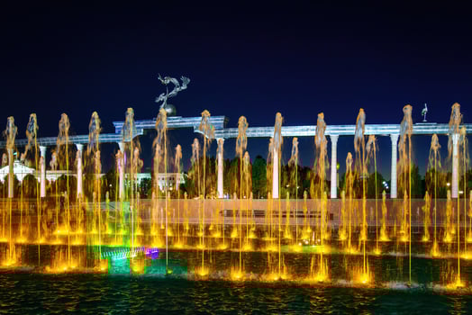 Memorial and rows of fountains with illumination in the Independence Square at summertime in nighttime, Tashkent, Uzbekistan. photo