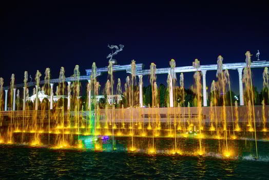Memorial and rows of fountains with illumination in the Independence Square at summertime in nighttime, Tashkent, Uzbekistan. photo