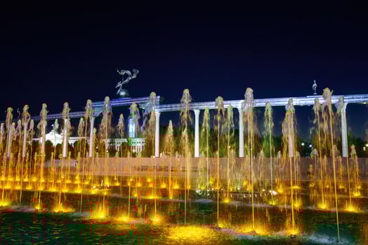 Memorial and rows of fountains with illumination in the Independence Square at summertime in nighttime, Tashkent, Uzbekistan. photo