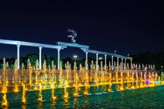 Memorial and rows of fountains with illumination in the Independence Square at summertime in nighttime, Tashkent, Uzbekistan. photo