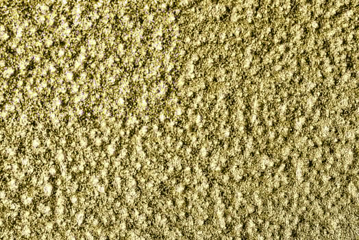 Golden texture of shiny grained metal. Abstract gold background. photo
