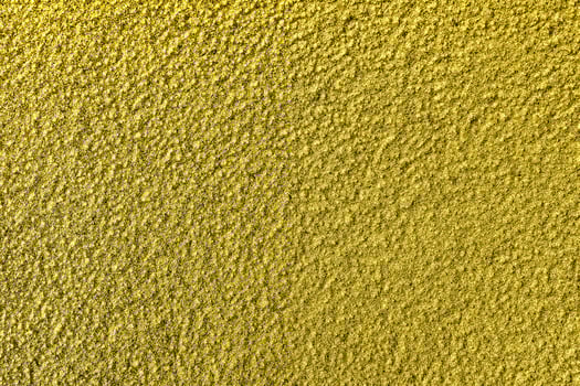 Golden texture of shiny grained metal. Abstract gold background. photo