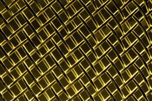 Golden texture of a shiny metal colander or grate. Abstract gold background. photo