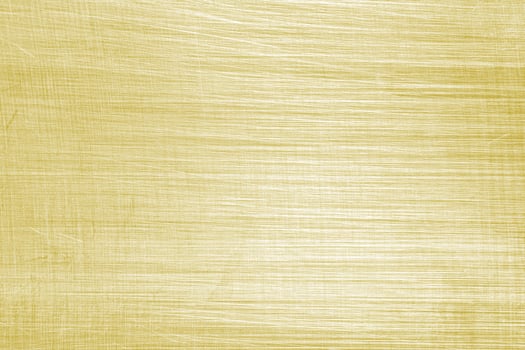 Golden texture of shiny scratched metal. Abstract gold background. photo