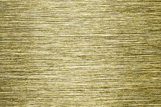 Golden texture of shiny scratched metal. Abstract gold background. photo
