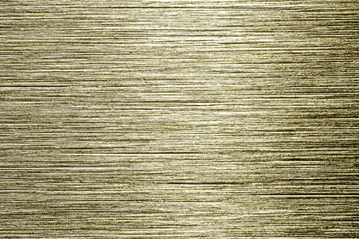 Golden texture of shiny scratched metal. Abstract gold background. photo