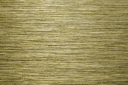 Golden texture of shiny scratched metal. Abstract gold background. photo