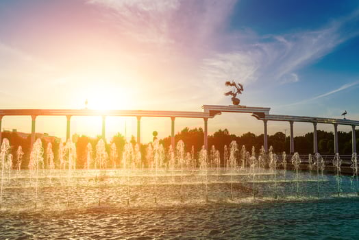 Memorial and rows of fountains illuminated by sunlight at sunset or sunrise in the Independence Square at summertime, Tashkent. photo