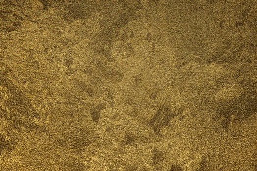 Texture of golden decorative plaster or concrete. Abstract gold grunge background. photo