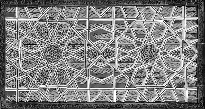 Geometric traditional Islamic ornament. Fragment of a ceramic mosaic. Black and white. photo